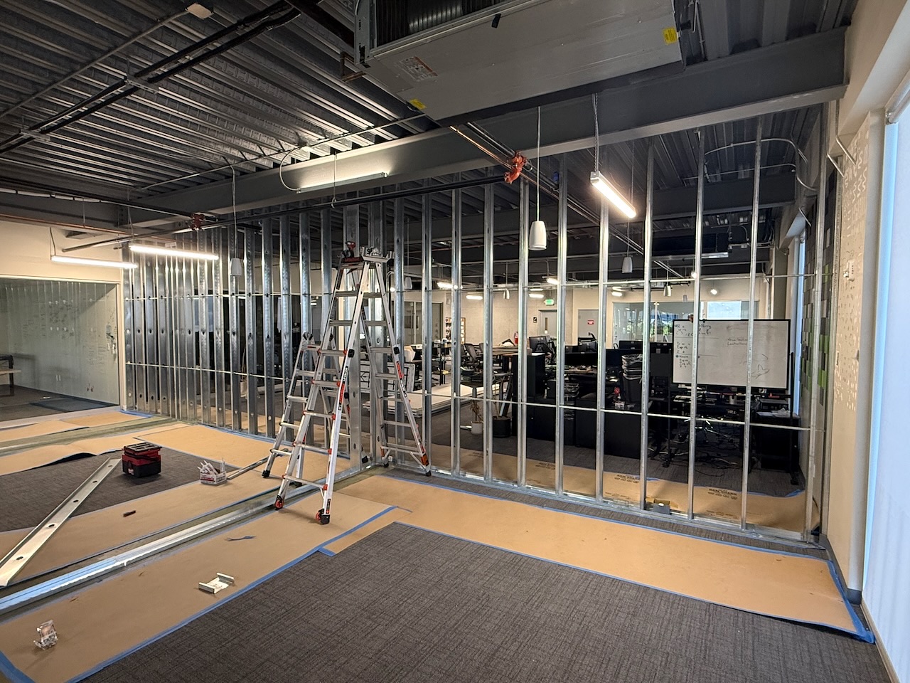 Kaart owner's representative overseeing construction alongside an occupied office space