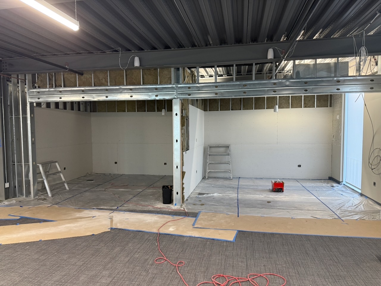 Framed-out rooms mid-construction on a Kaart general contracting project